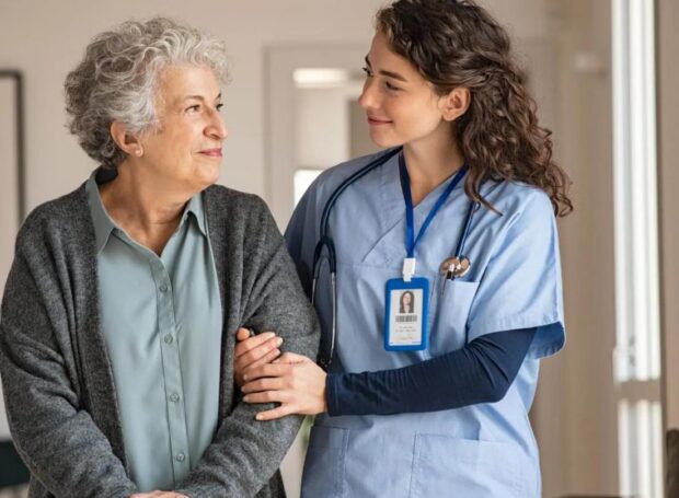 Nurse supporting an older patient